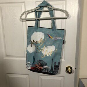 Papyrus light teal book bag marked "Ready Set Jet"